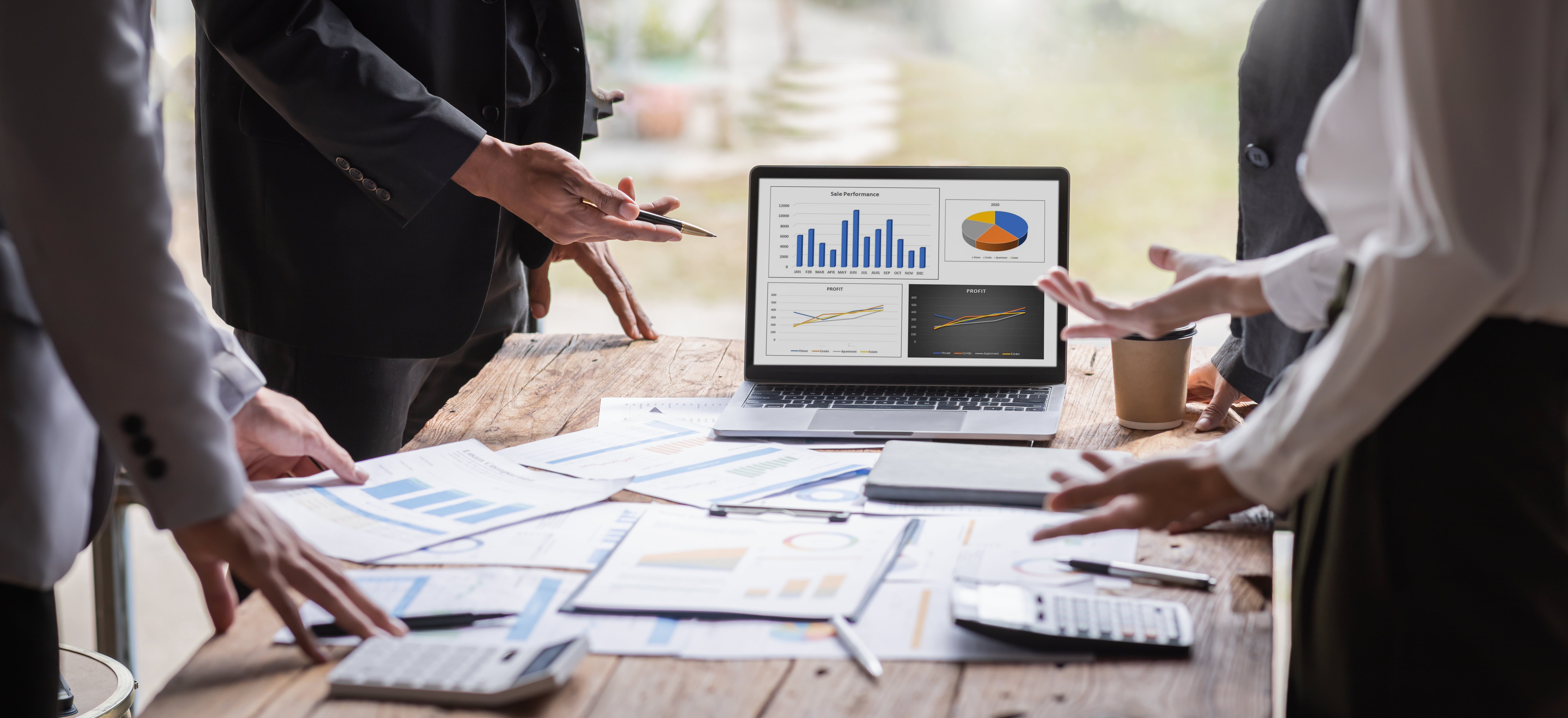 Business professionals analyzing graphs and data on laptop for digital transformation.