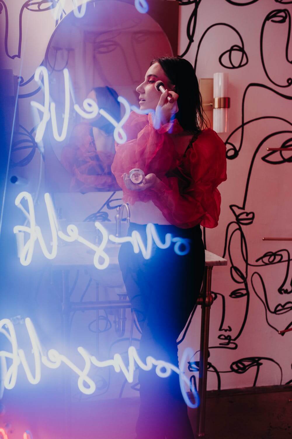 a person standing in front of a wall with text