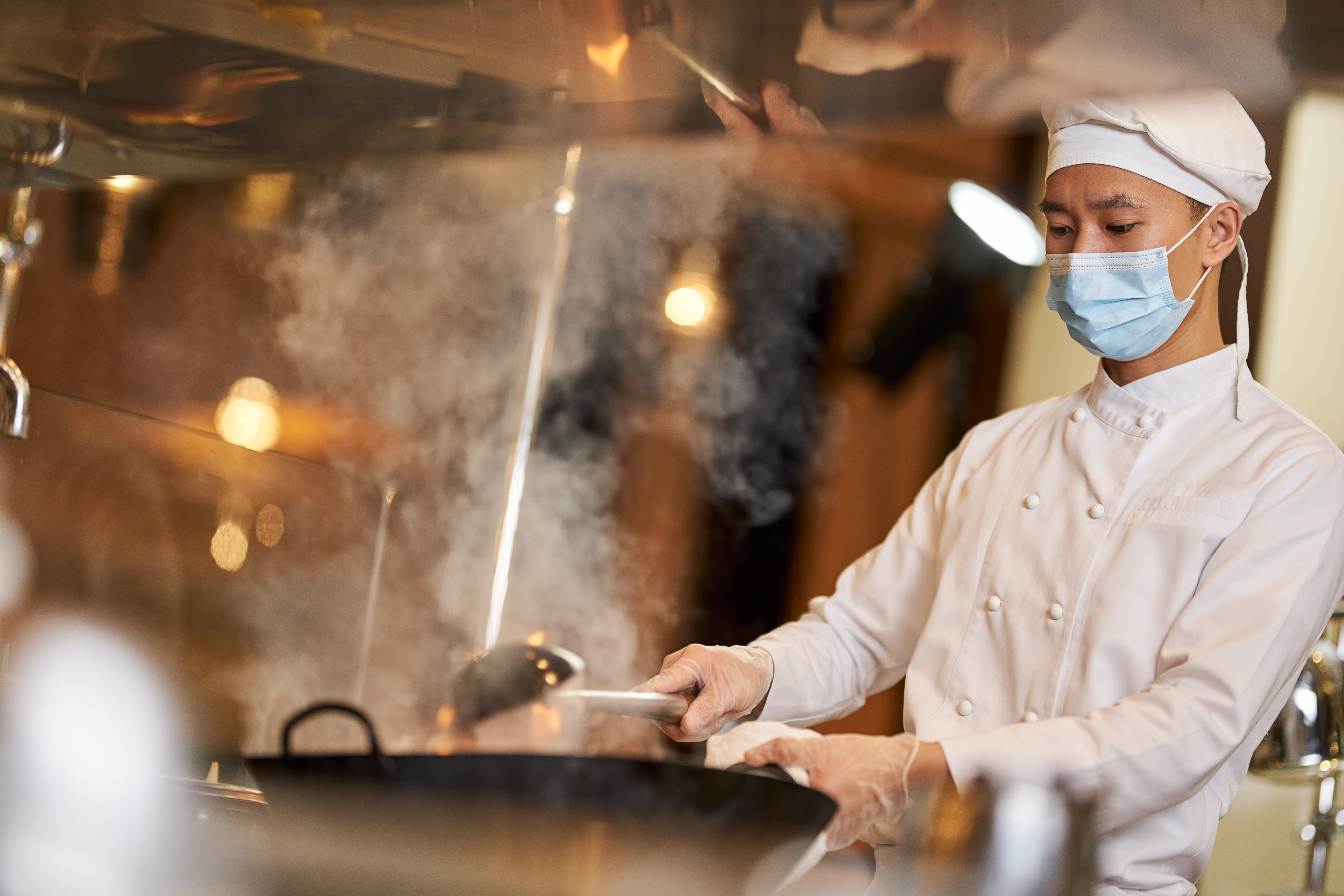 Chef preparing a steamy dish illustrating culinary arts career path