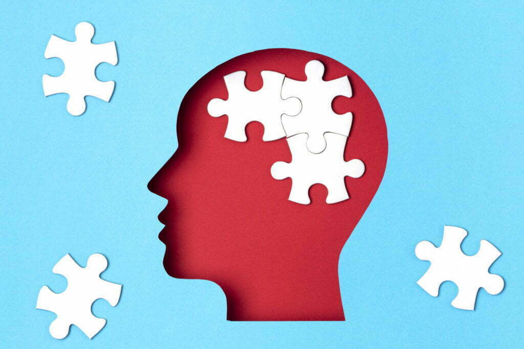 Head silhouette with jigsaw puzzle pieces inside representing complex topics and lifestyle content.