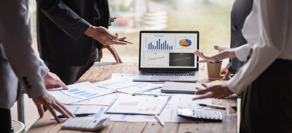 Business professionals analyzing graphs and data on laptop, career resources and insights.