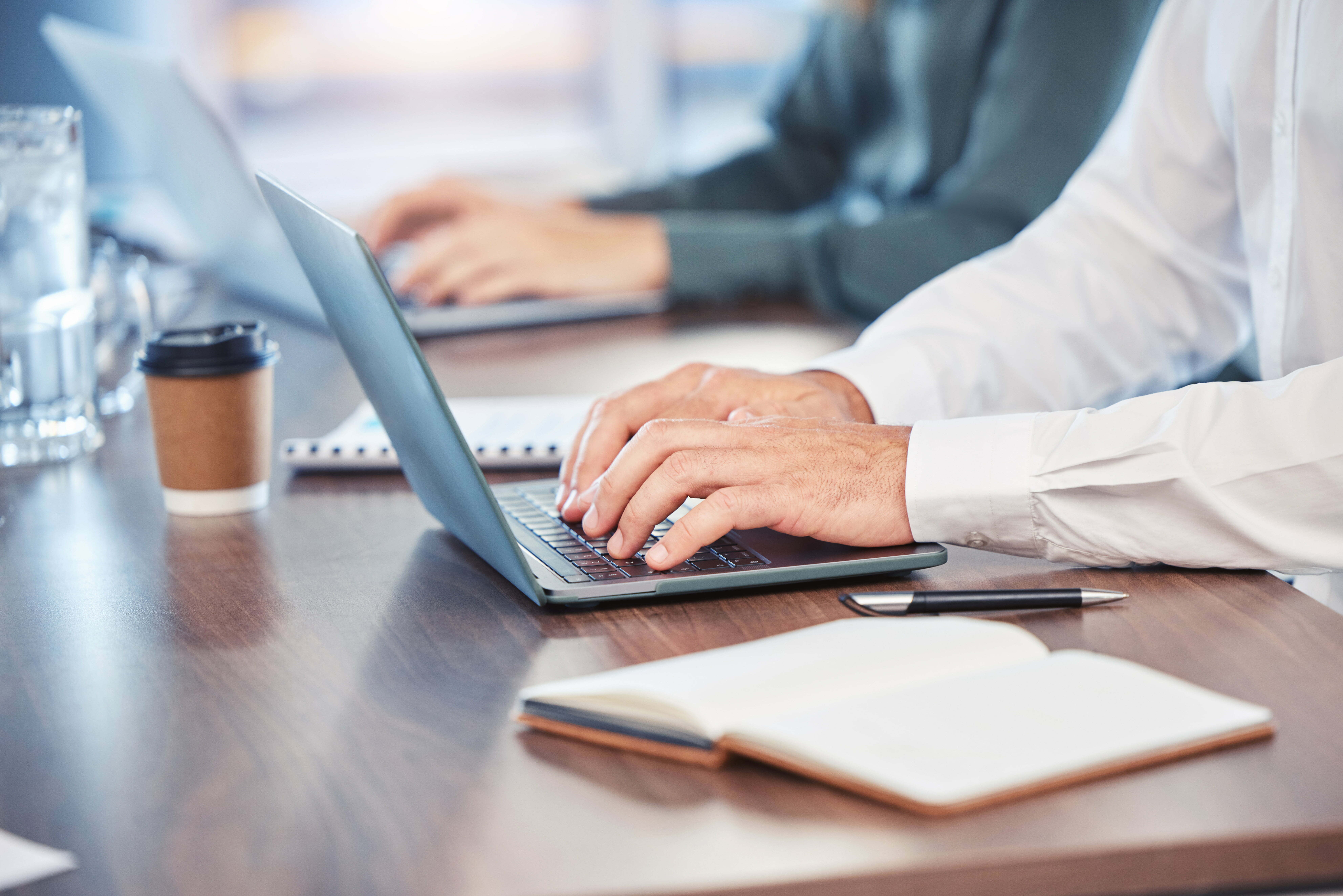 Businessman using laptop for background checks and identity verification