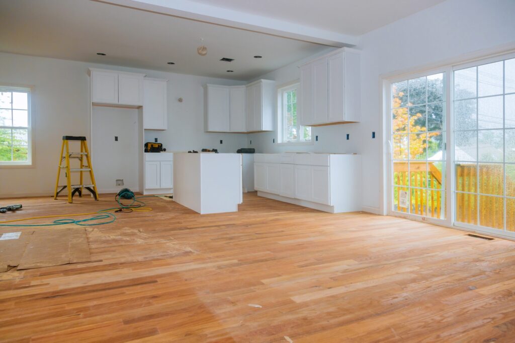 Newly remodeled kitchen with white cabinetry and island, home improvement project financing guide